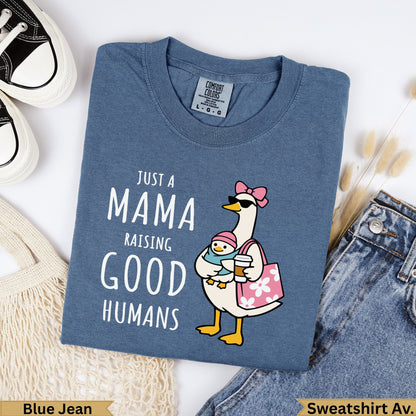 Blue t-shirt with "Just a Mama Raising Good Humans" graphic featuring a goose holding coffee.