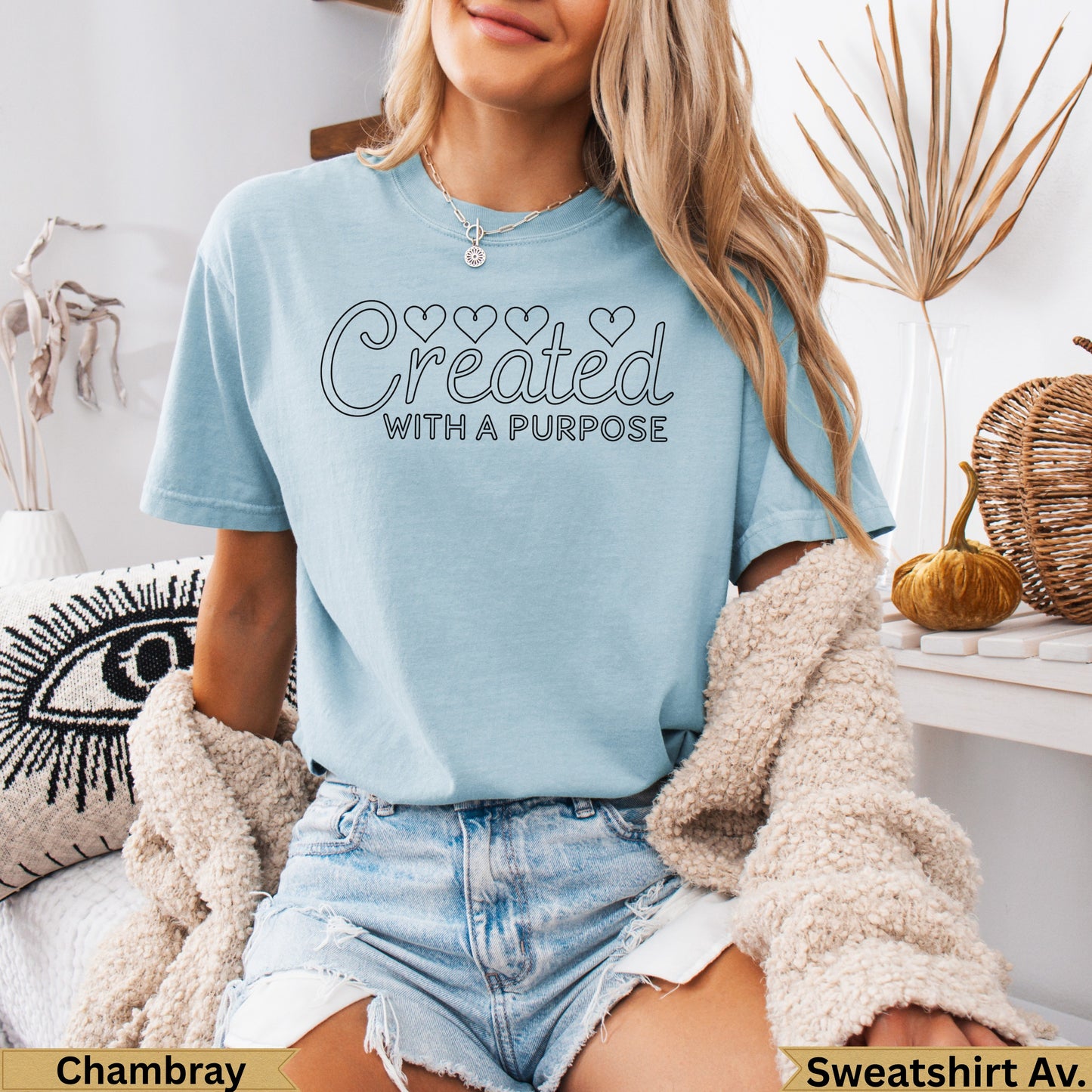 Light blue t-shirt with "Created WITH HEART Purpose" text and denim shorts.