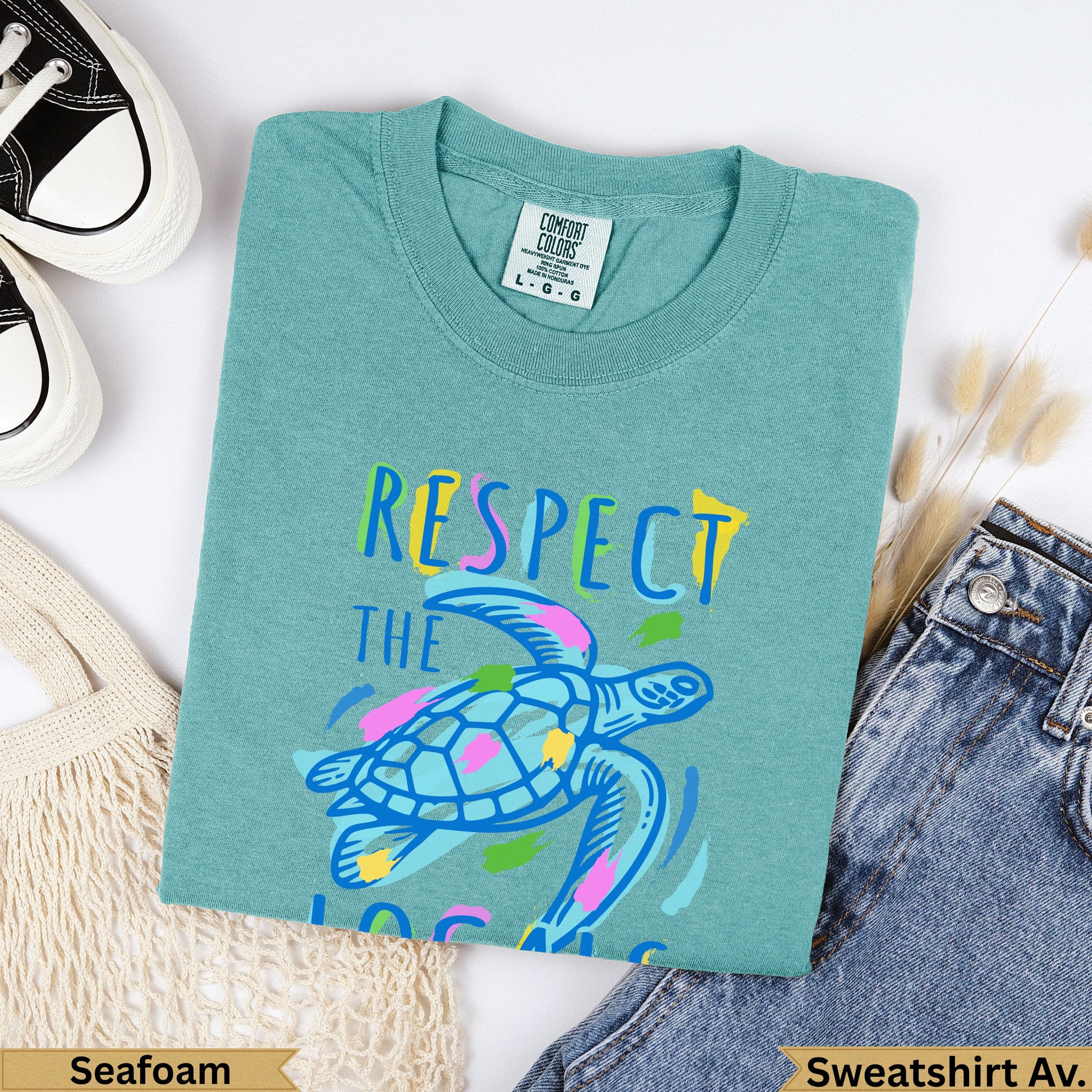 Teal t-shirt with "Respect the Ocean" text and sea turtle graphic.