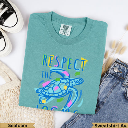 Teal t-shirt with "Respect the Ocean" text and sea turtle graphic.