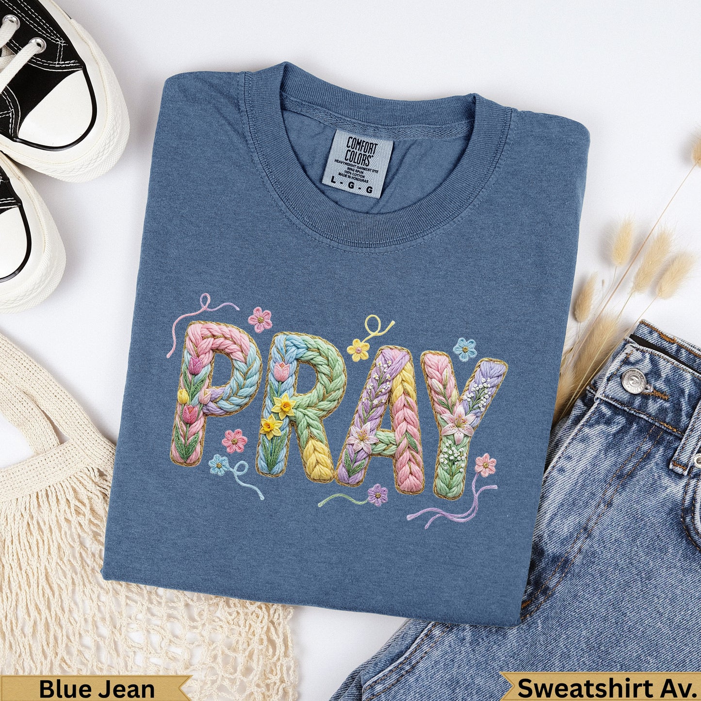 Blue Jean Comfort Colors t-shirt with "PRAY" embroidered in pastel yarn.