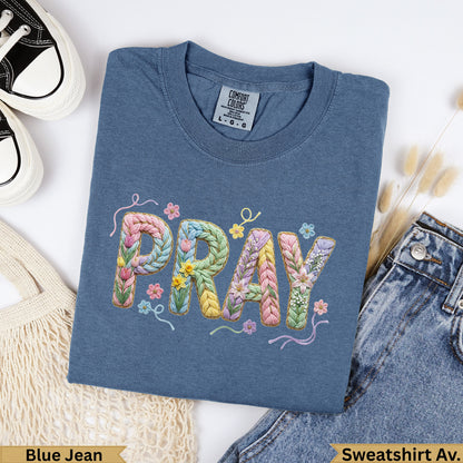 Blue Jean Comfort Colors t-shirt with "PRAY" embroidered in pastel yarn.