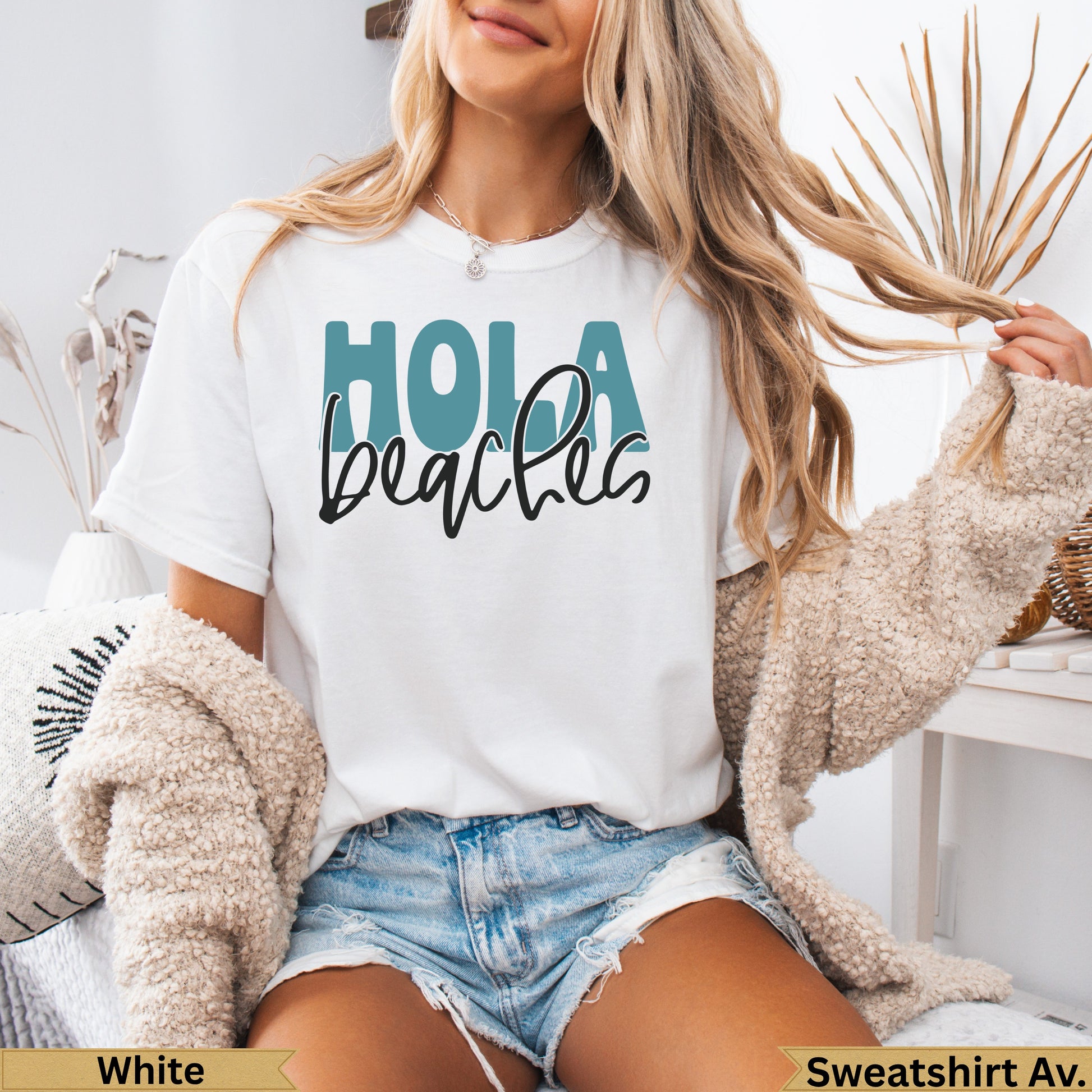 White t-shirt with "Hola beaches" text and distressed denim shorts.