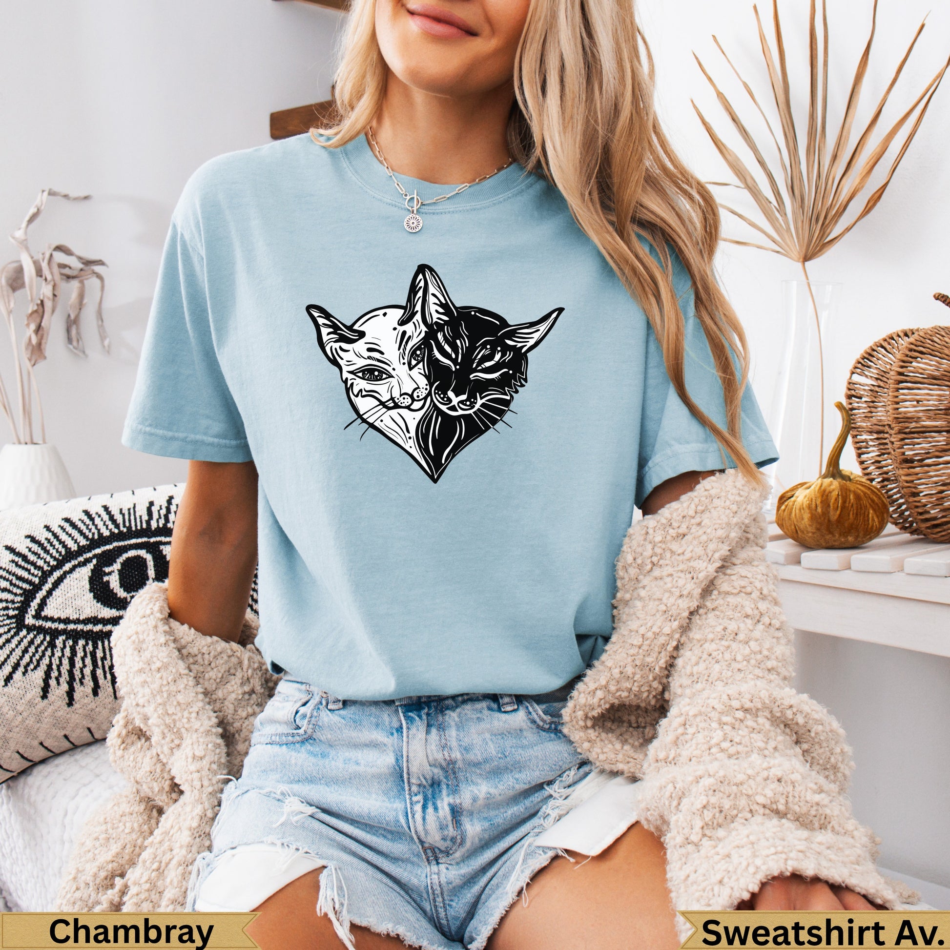 Light blue t-shirt with split black and white cat heart graphic.