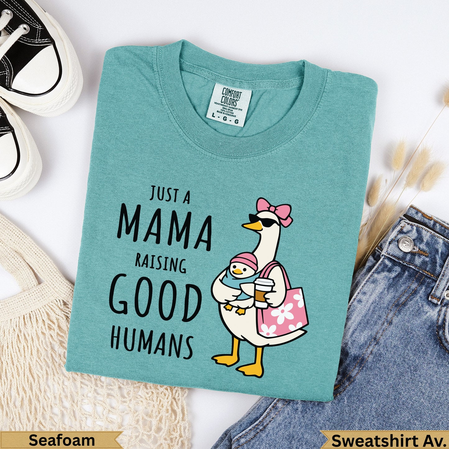 Teal Comfort Colors sweatshirt with duck and text "Just a Mama Raising Good Humans".