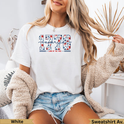 White t-shirt with "1776 LAND OF THE FREE" text in red, white, and blue.