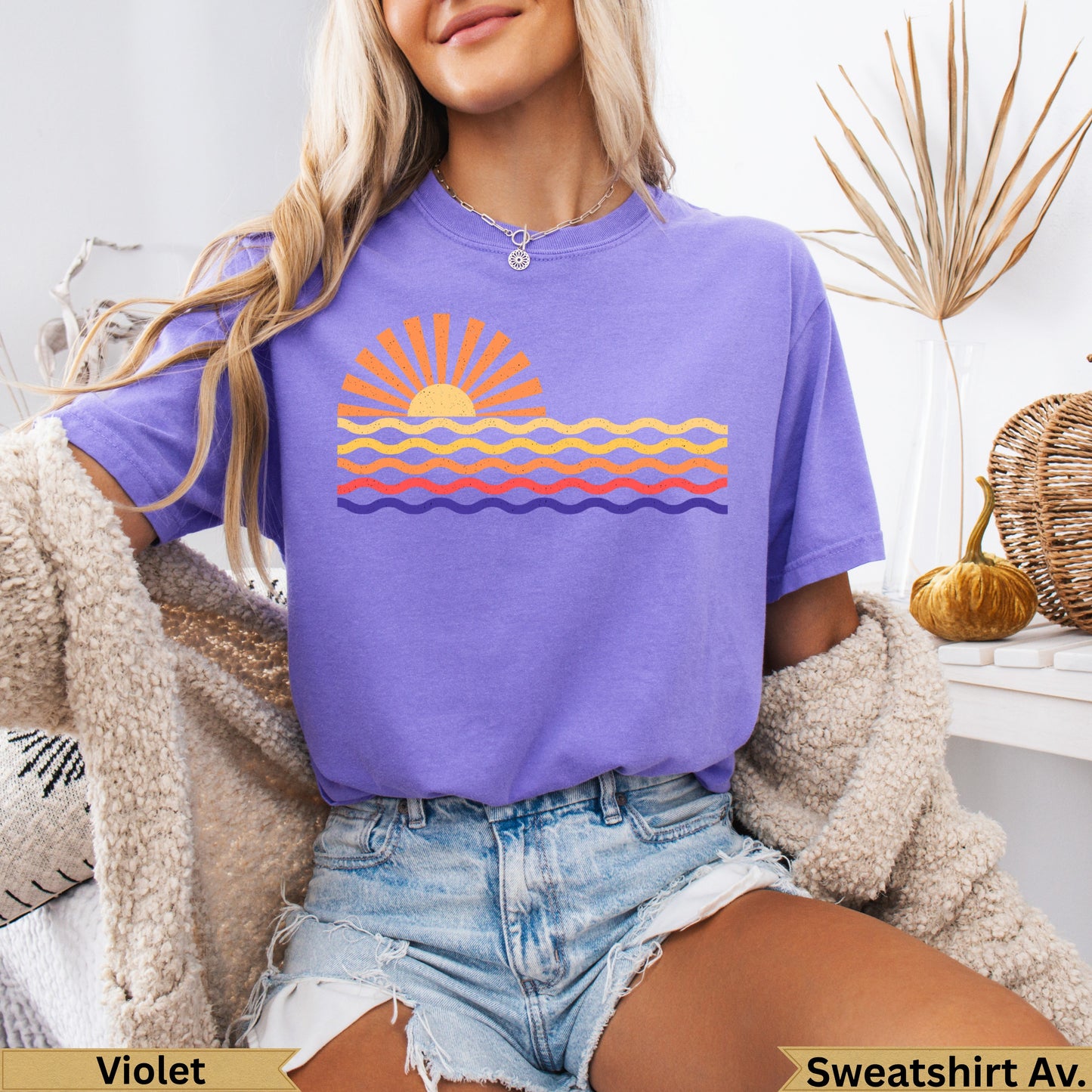 Purple t-shirt with sun and wavy stripes graphic.