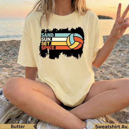 Yellow t-shirt with "SAND. SUN. SET. SPIKE." and volleyball graphic.