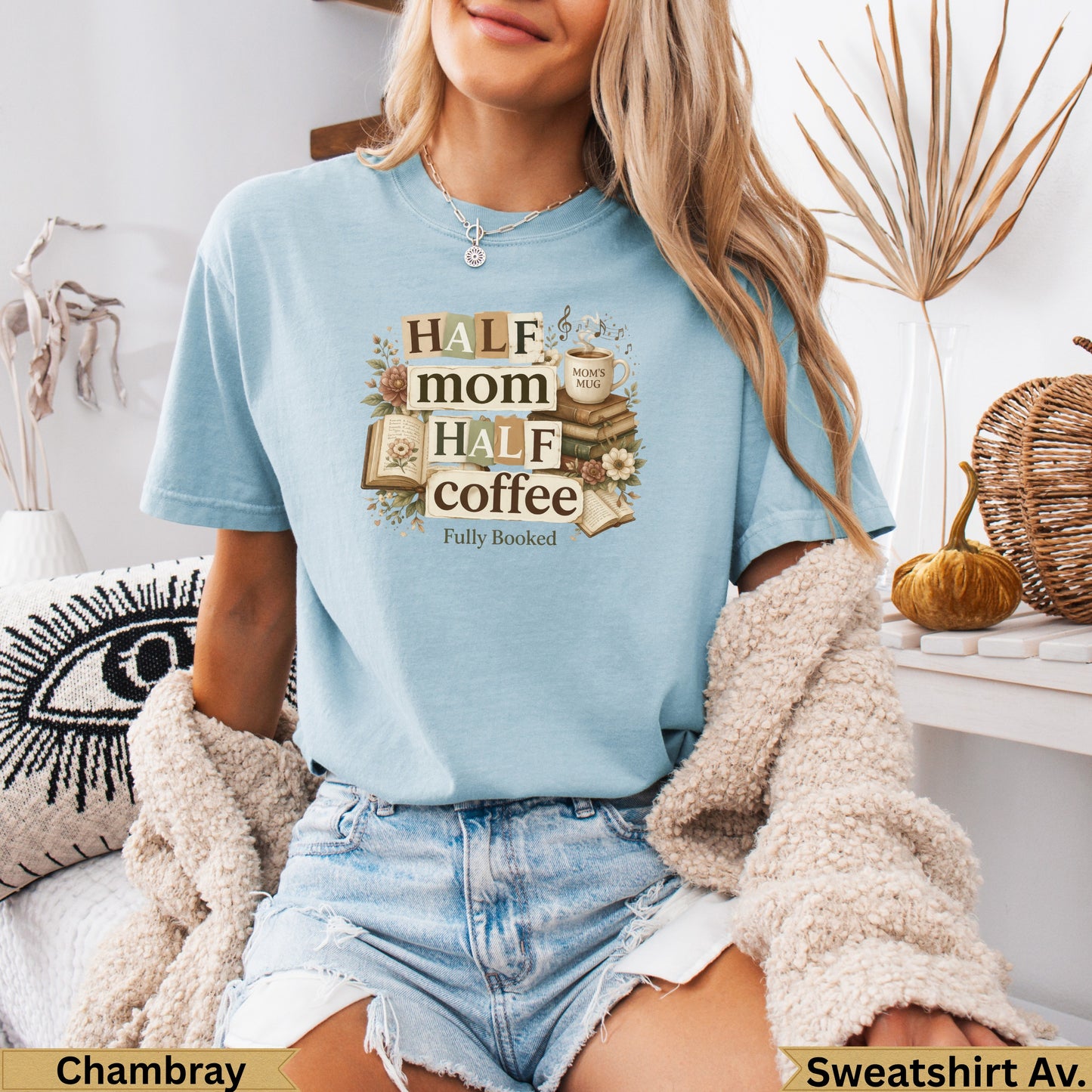 Light blue t-shirt with "Half Mom Half Coffee Fully Booked" text, flowers, and books.