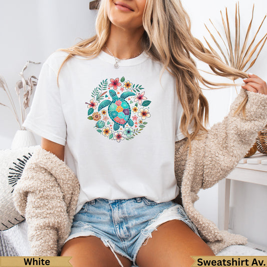 White t-shirt with a colorful sea turtle surrounded by floral wreath.