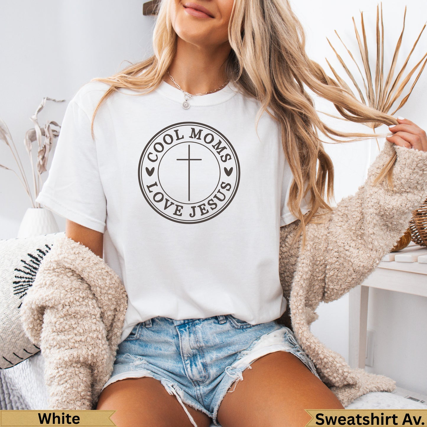 White crew neck t-shirt with "Cool Moms Love Jesus" and cross graphic.