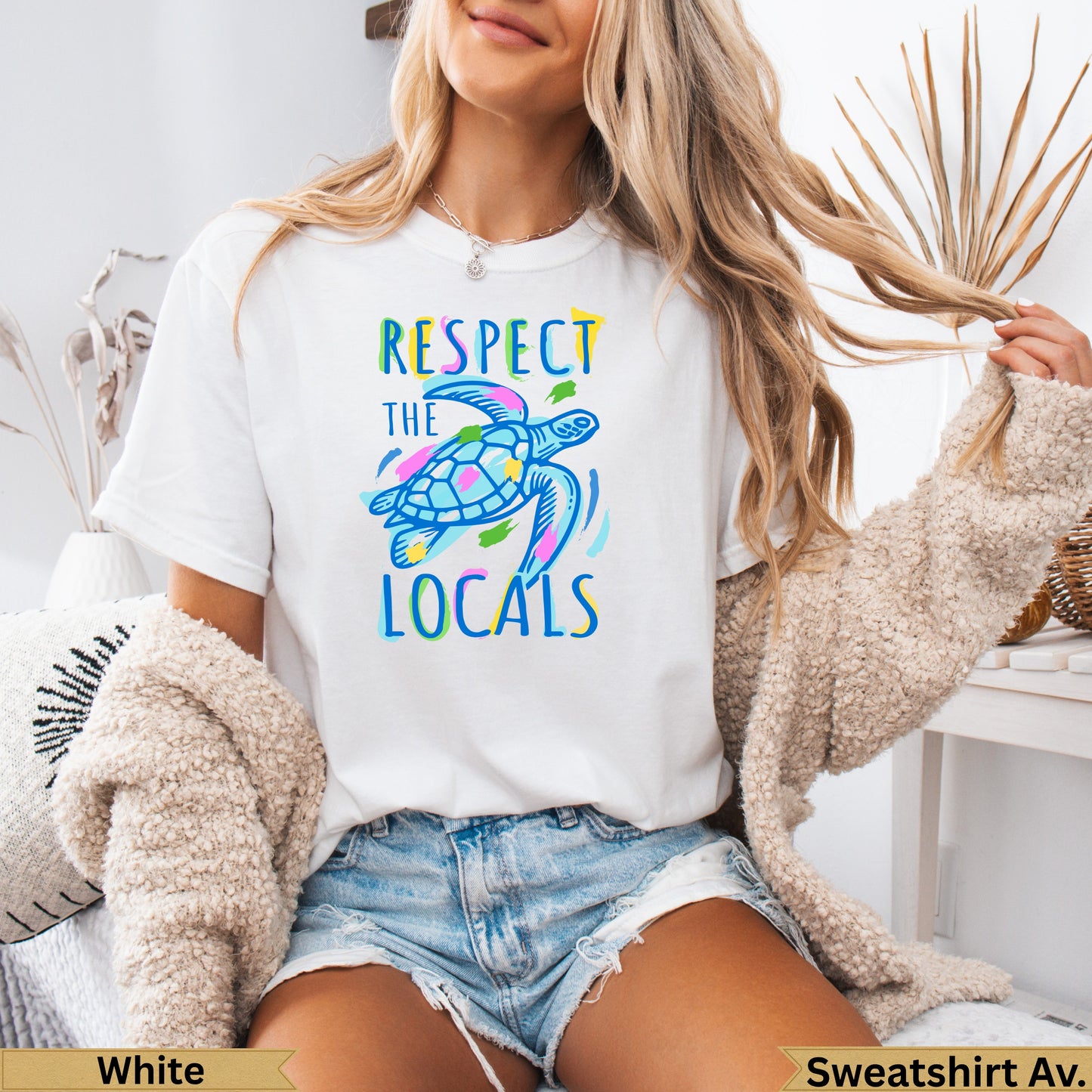 White t-shirt with colorful sea turtle graphic and "Respect the Locals" text.