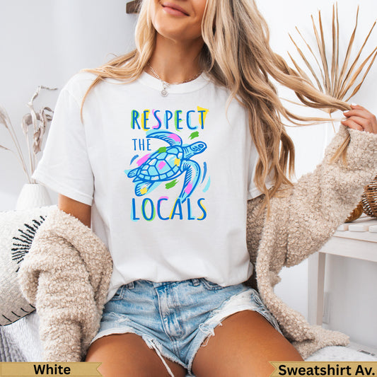 White t-shirt with colorful sea turtle graphic and "Respect the Locals" text.
