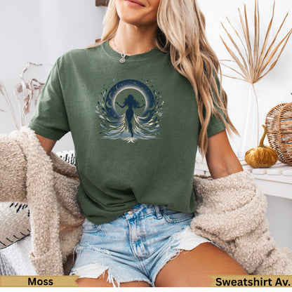 Woman wearing olive green t-shirt with celestial moon and woman graphic.