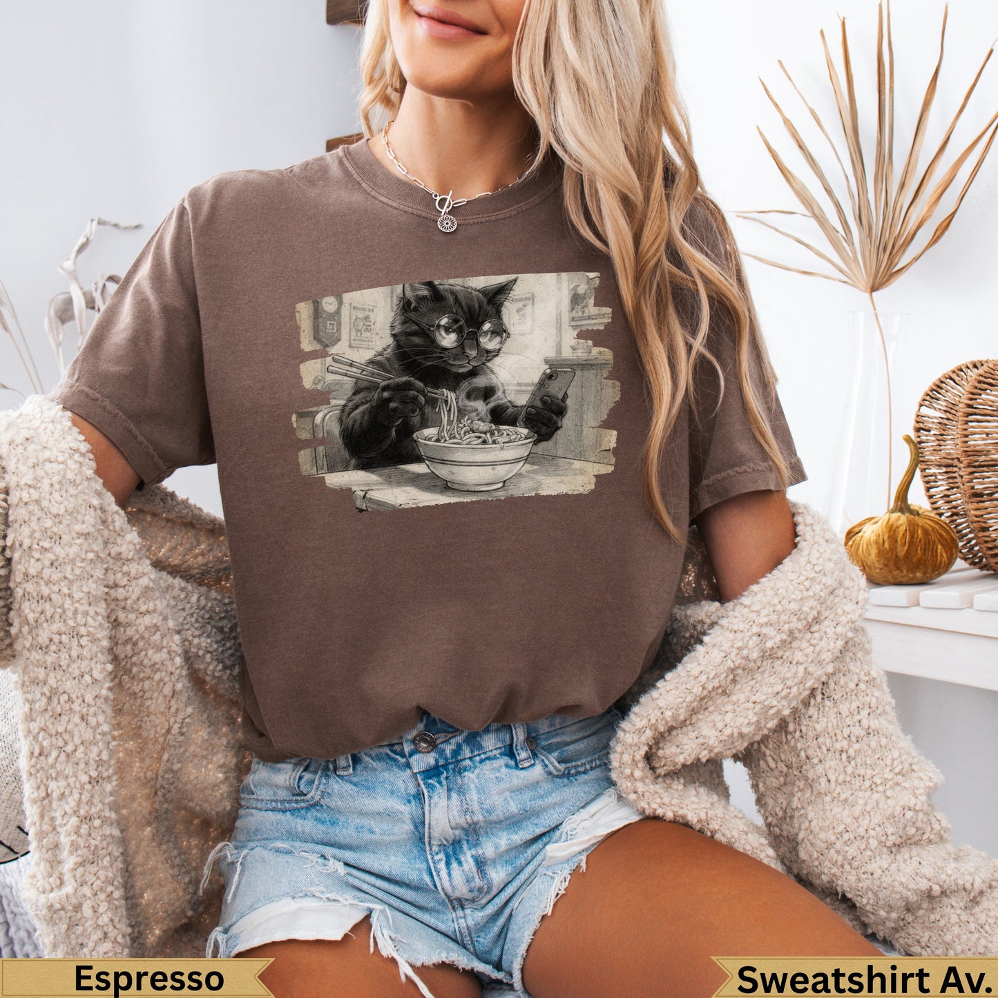 Graphic tee with black cat wearing glasses eating ramen.