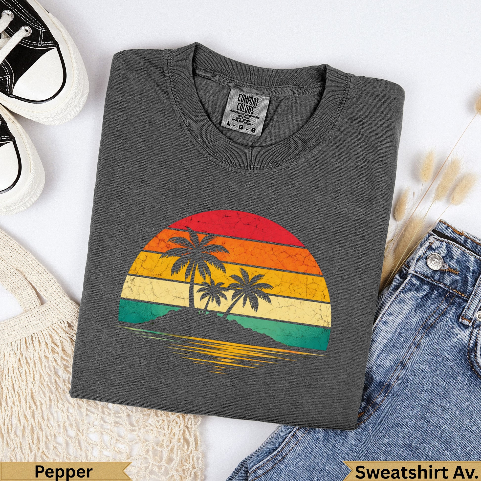 Dark grey Comfort Colors sweatshirt with vintage sunset graphic of palm trees.