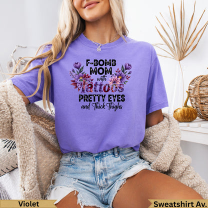 Purple sweatshirt with "F-BOMB MOM with tattoos PRETTY EYES and Thick Thighs" text.