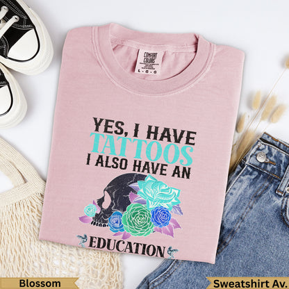 Pink t-shirt with "Yes, I have tattoos, I also have an education" text and skull graphic.