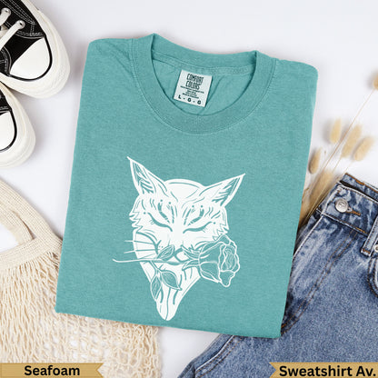 Teal sweatshirt with white bobcat and rose graphic, "Seafoam" and "Sweatshirt Av." text.
