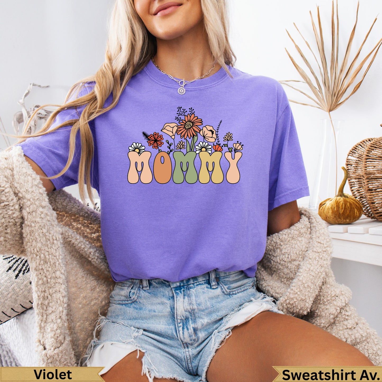 Purple t-shirt with "Mommy" in colorful block letters and floral accents.