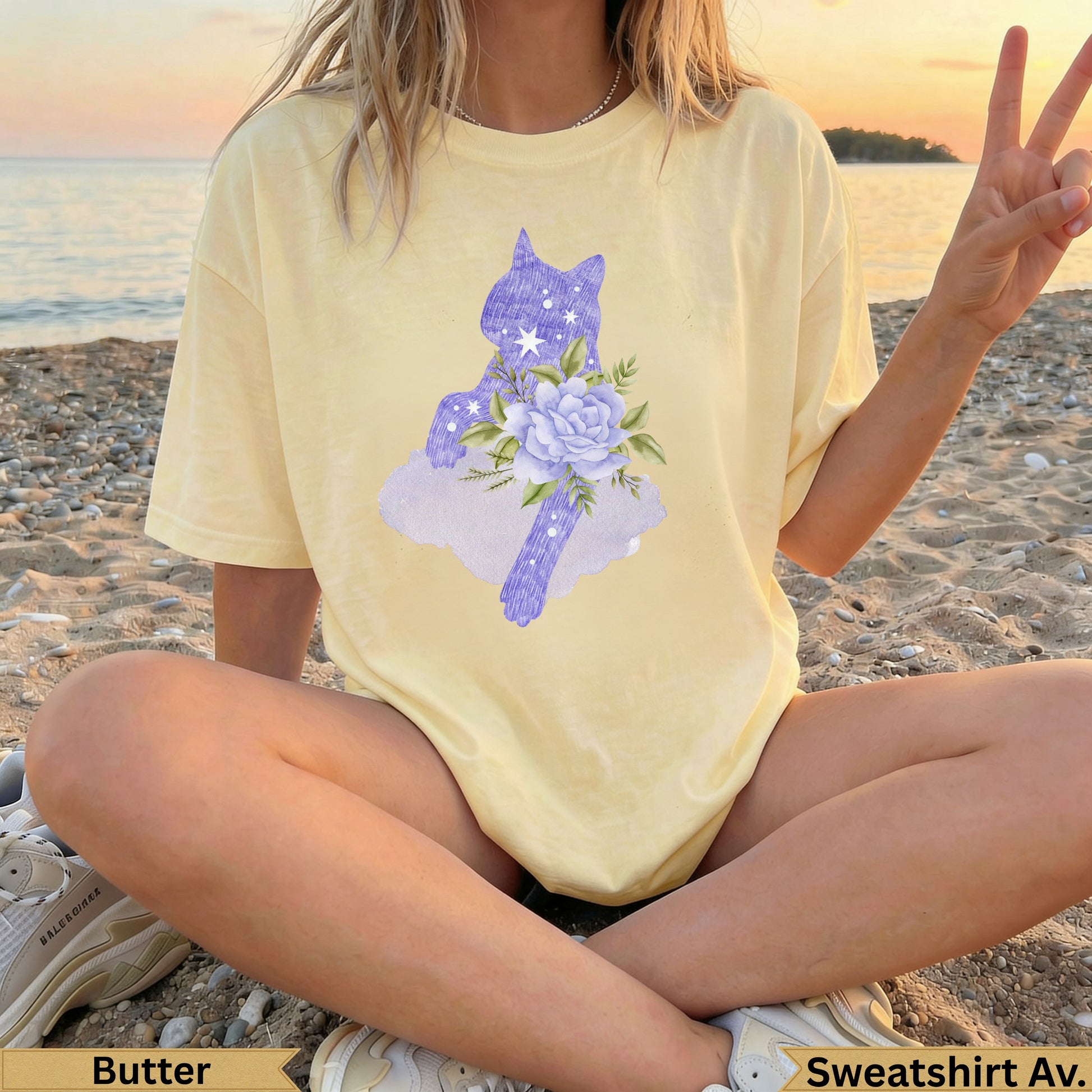 Yellow t-shirt with purple cat illustration and floral accents.