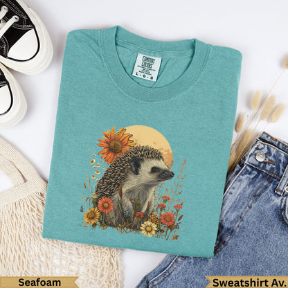 Teal sweatshirt with hedgehog and floral graphic, "Seafoam" and "Sweatshirt Av." labels.