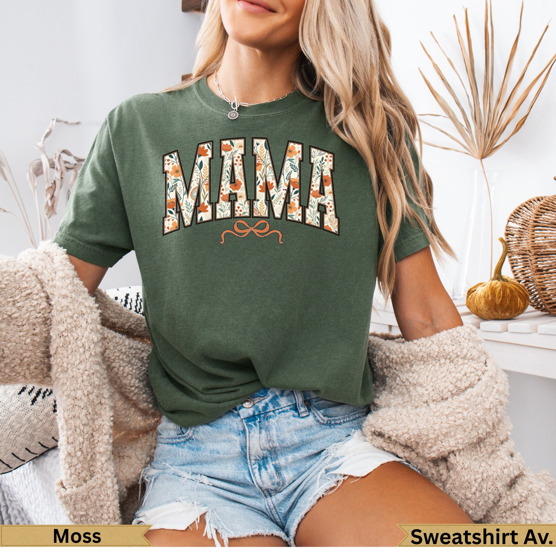 Green sweatshirt with "MAMA" in floral print and a small orange bow.