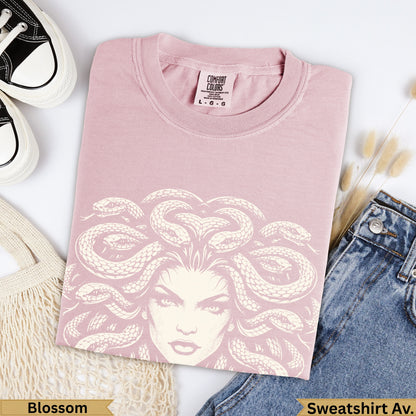 Pink Comfort Colors t-shirt with Medusa graphic, jeans, and shoes.