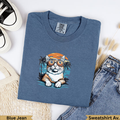 T-shirt with a cat wearing sunglasses and a beach scene design.