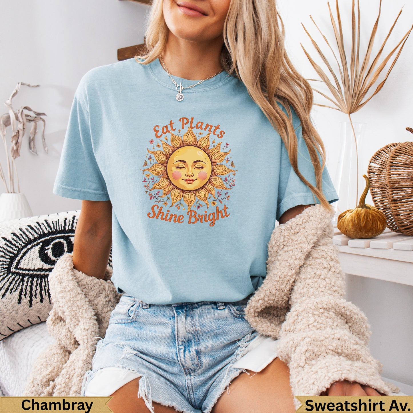 Light blue t-shirt with sun graphic and "Eat Plants Shine Bright" text.