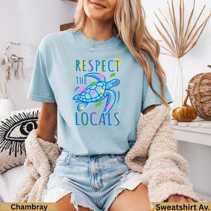 Light blue t-shirt with "Respect the Locals" text and a colorful sea turtle.