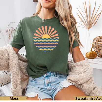 Green t-shirt with a sun and waves graphic, suitable for activewear.