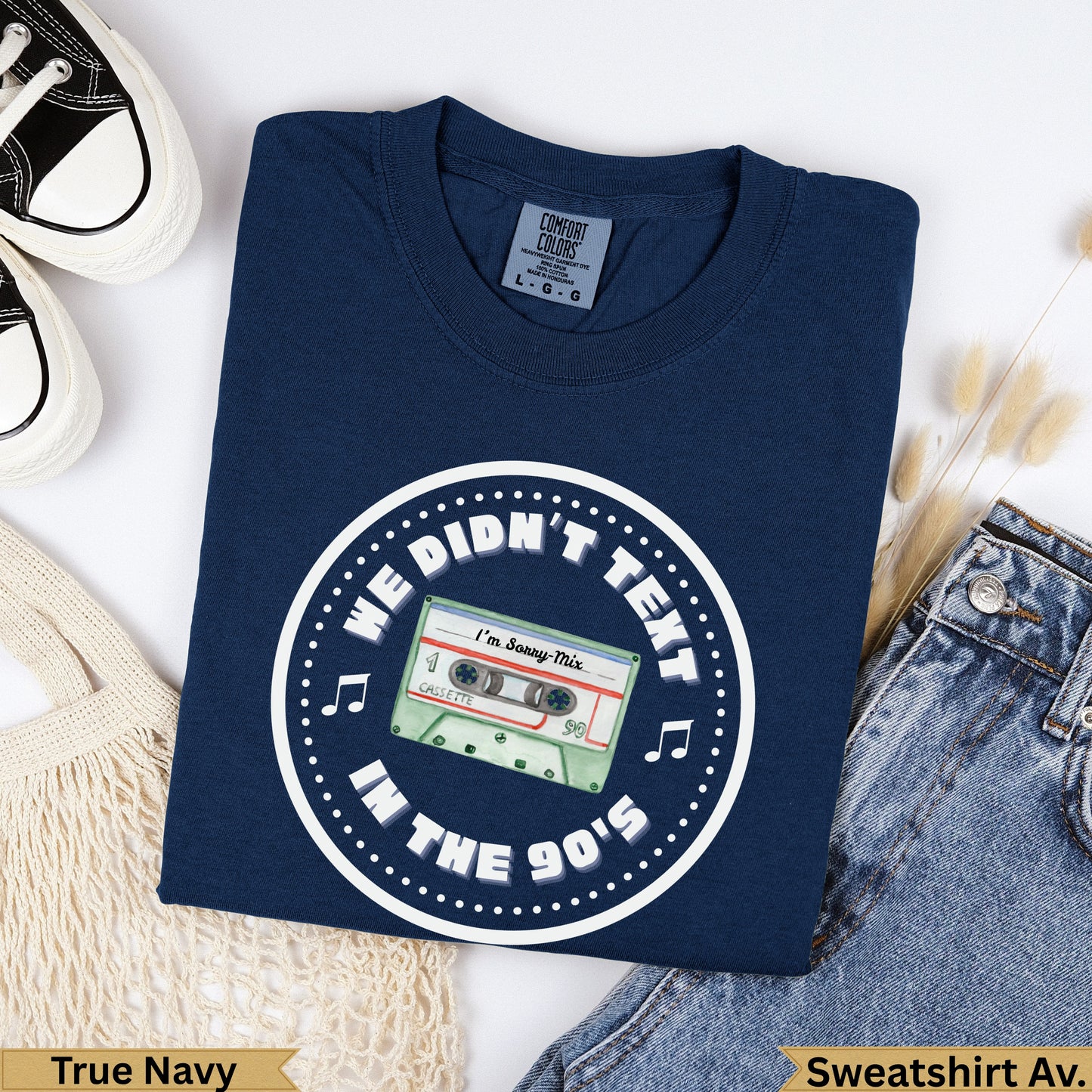 Navy crewneck sweatshirt with "We Didn't Text In The 90's" and cassette tape graphic.