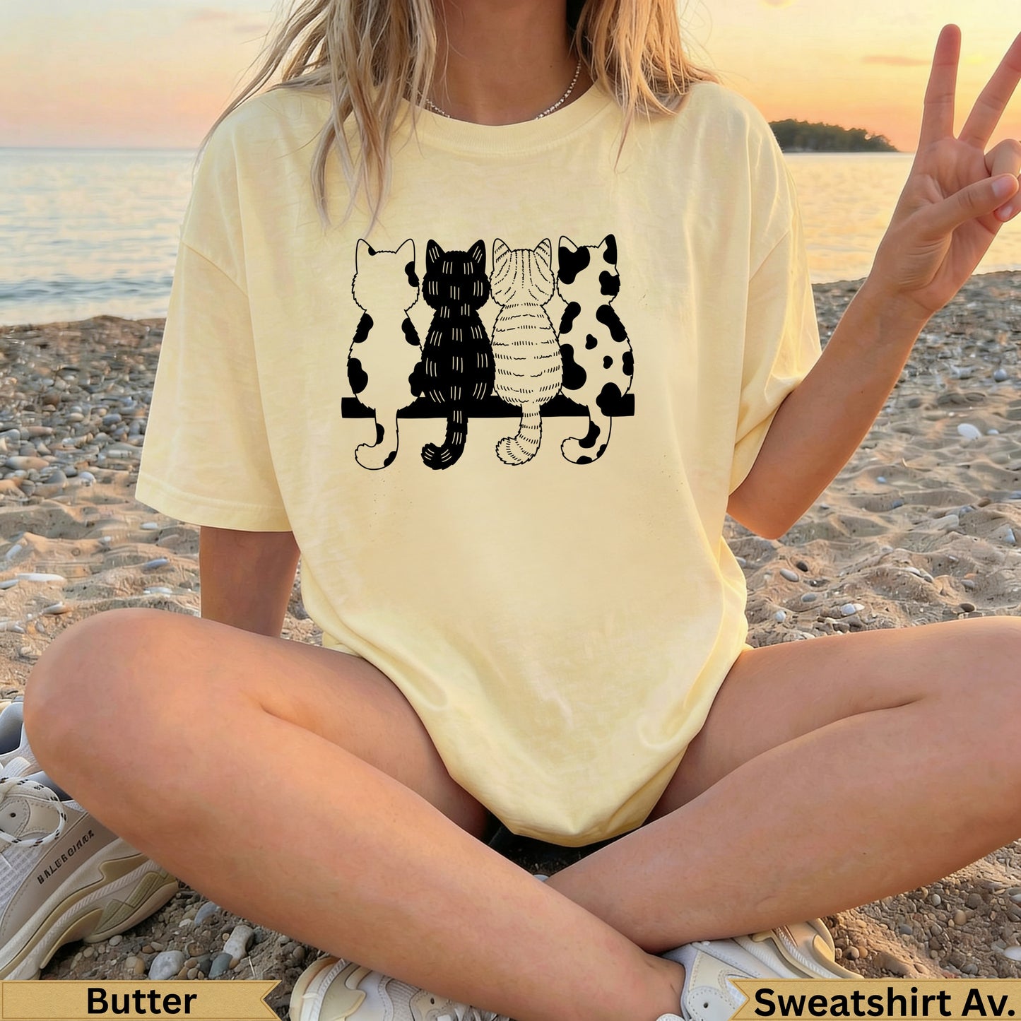 Yellow t-shirt with four silhouetted cats sitting on a bench.