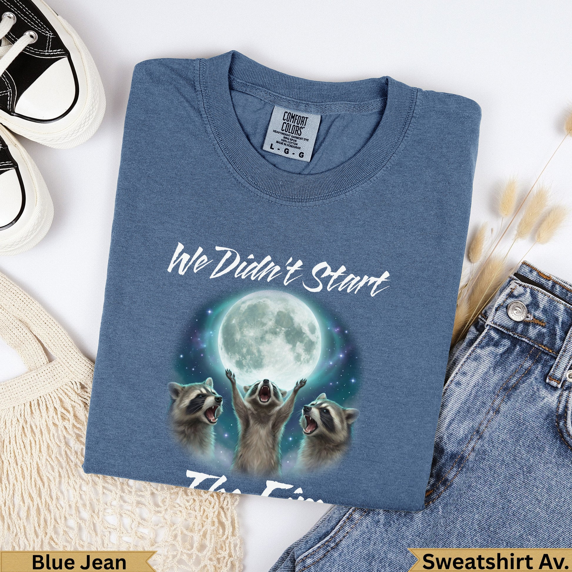 Blue Jean t-shirt with three raccoons looking up at a full moon, text "We Didn't Start".