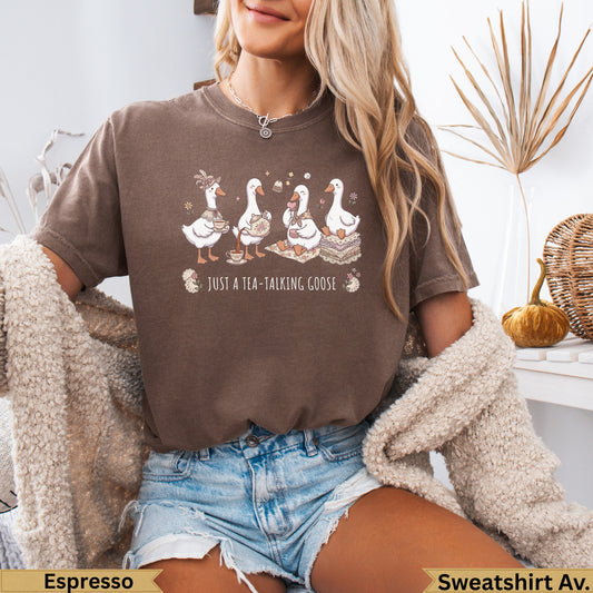 Brown t-shirt with four geese holding teacups, text "JUST A TEA-TALKING GOOSE".