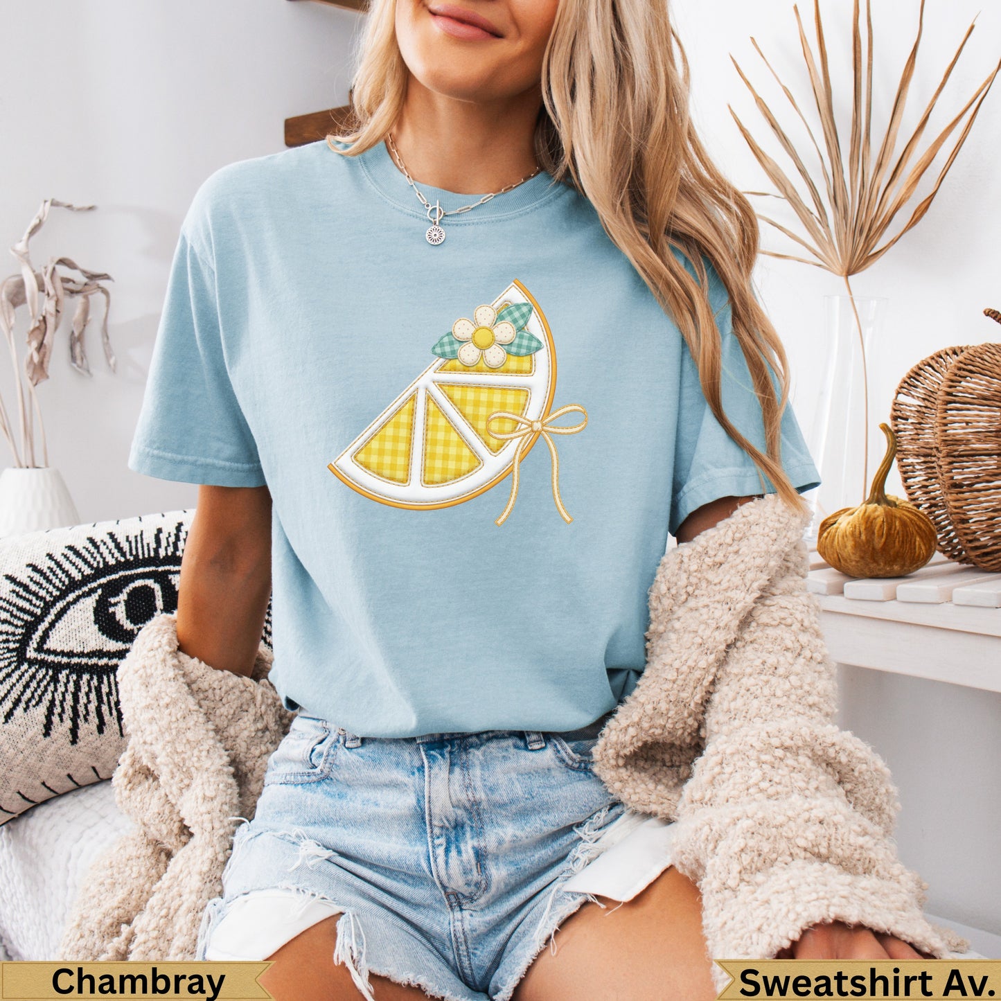 Light blue t-shirt with lemon slice graphic and "Chambray" and "Sweatshirt Av." text.