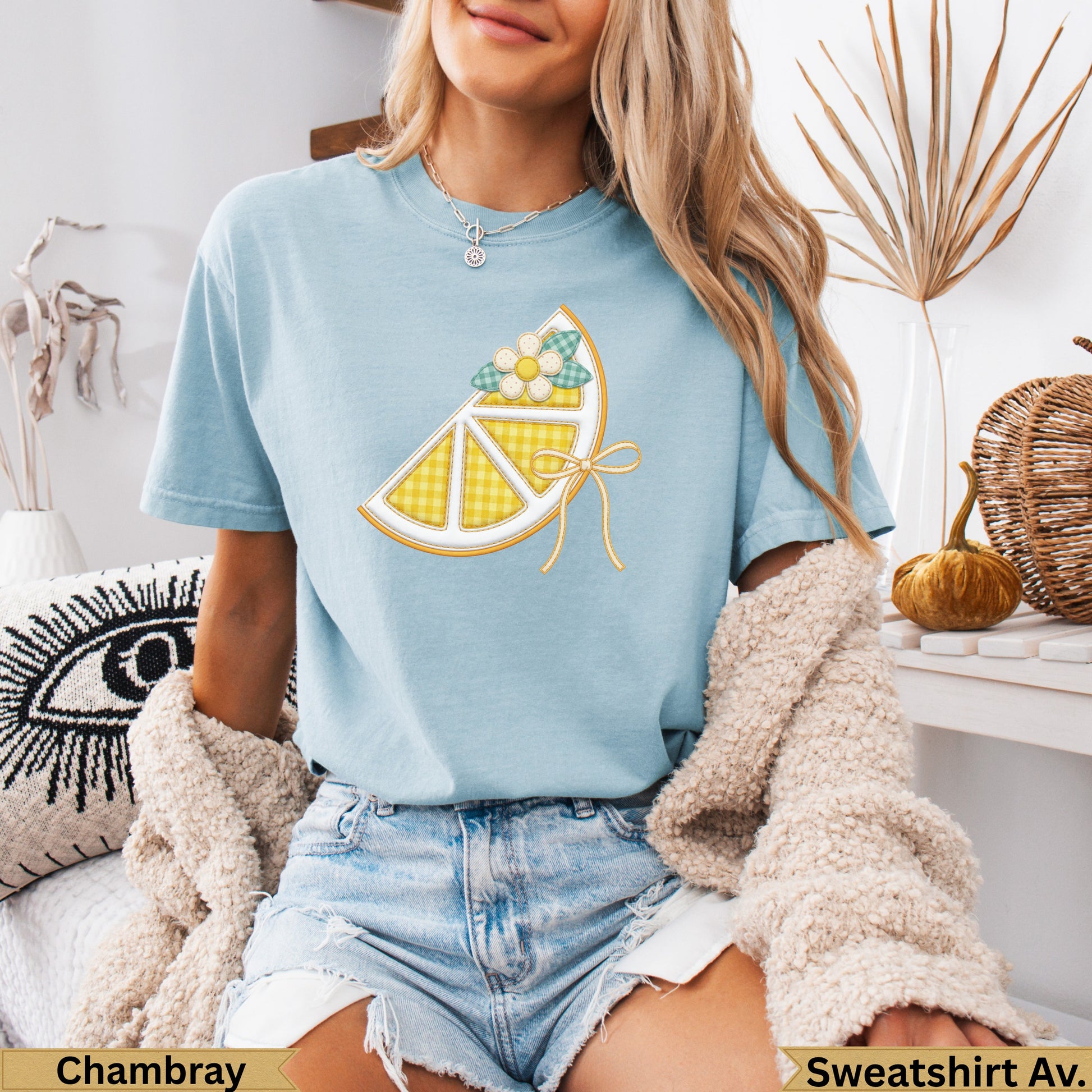 Light blue t-shirt with lemon slice graphic and "Chambray" and "Sweatshirt Av." text.