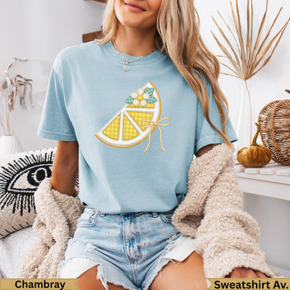 Light blue t-shirt with lemon slice graphic and "Chambray" and "Sweatshirt Av." text.