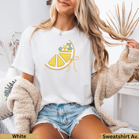 White t-shirt with a yellow checkered lemon slice graphic and ribbon tie.