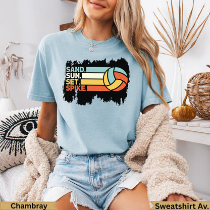 Light blue t-shirt with "SAND, SUN, SET, SPIKE" and volleyball graphic.