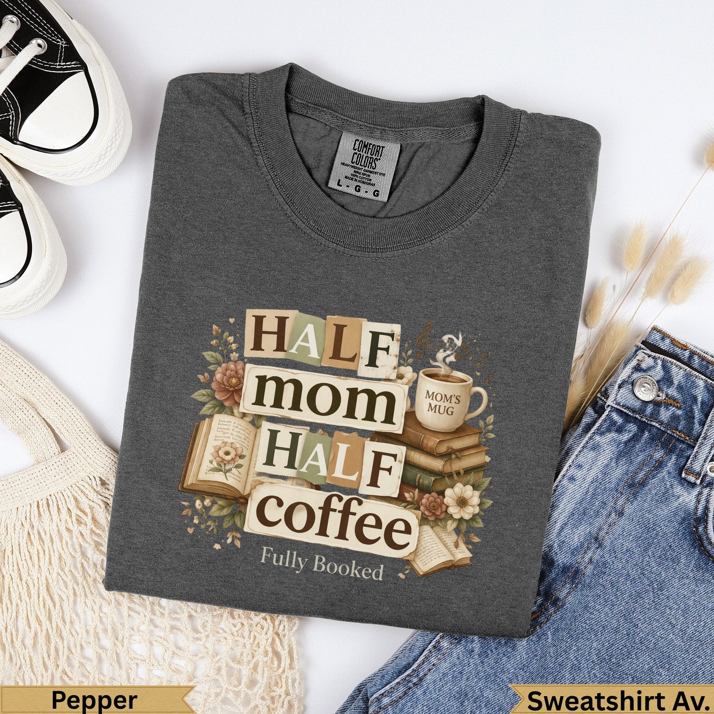 Dark gray sweatshirt with "Half mom, half coffee, fully booked" text and floral accents.