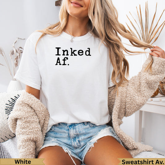 White t-shirt with "Inked Af." text, worn by a woman.