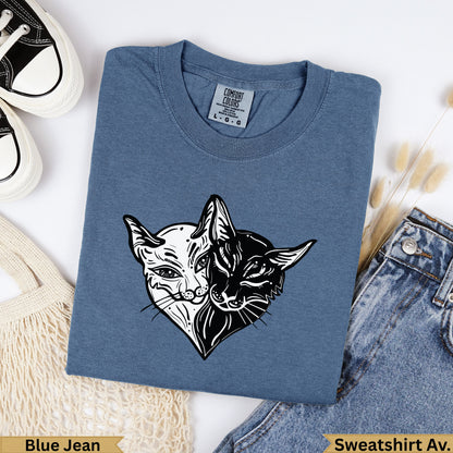 Blue Jean sweatshirt with split black and white cat heart graphic.