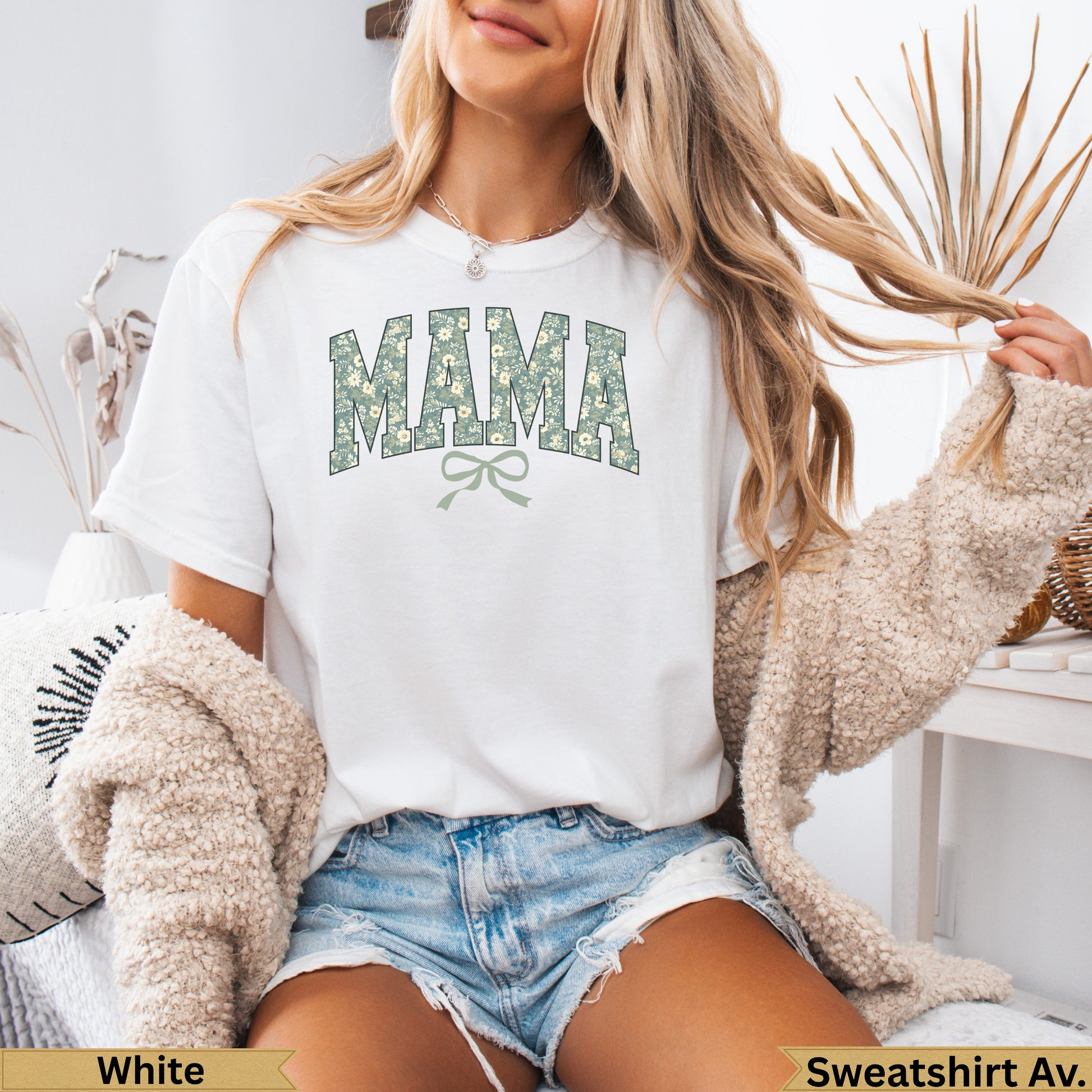White t-shirt with "MAMA" floral print and green bow graphic.