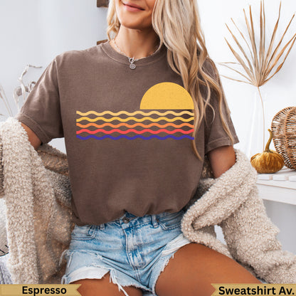 Brown crewneck sweatshirt with a sunset and wave graphic.