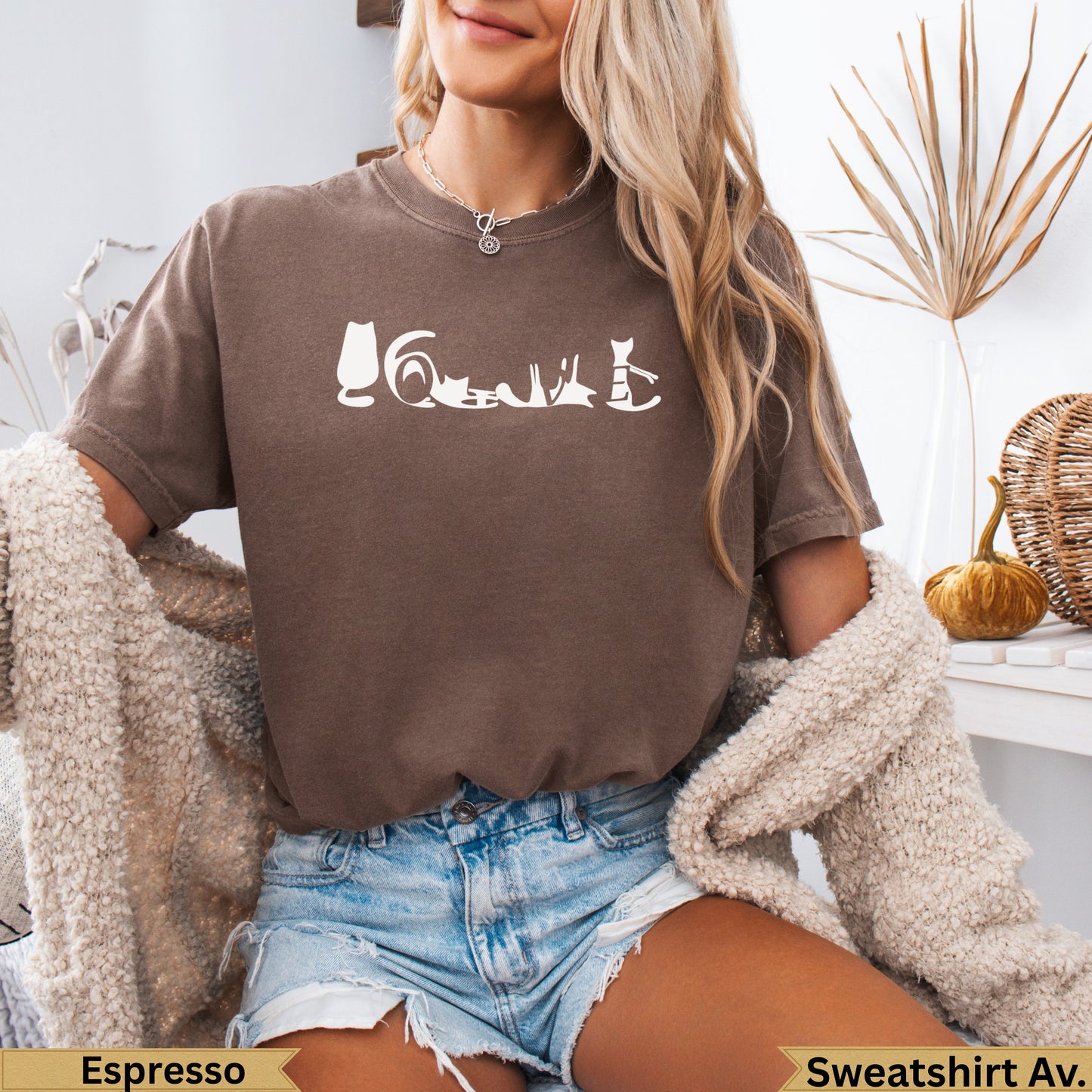Brown crewneck sweatshirt with a white line drawing of various cat poses across the chest.