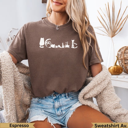 Brown crewneck sweatshirt with a white line drawing of various cat poses across the chest.