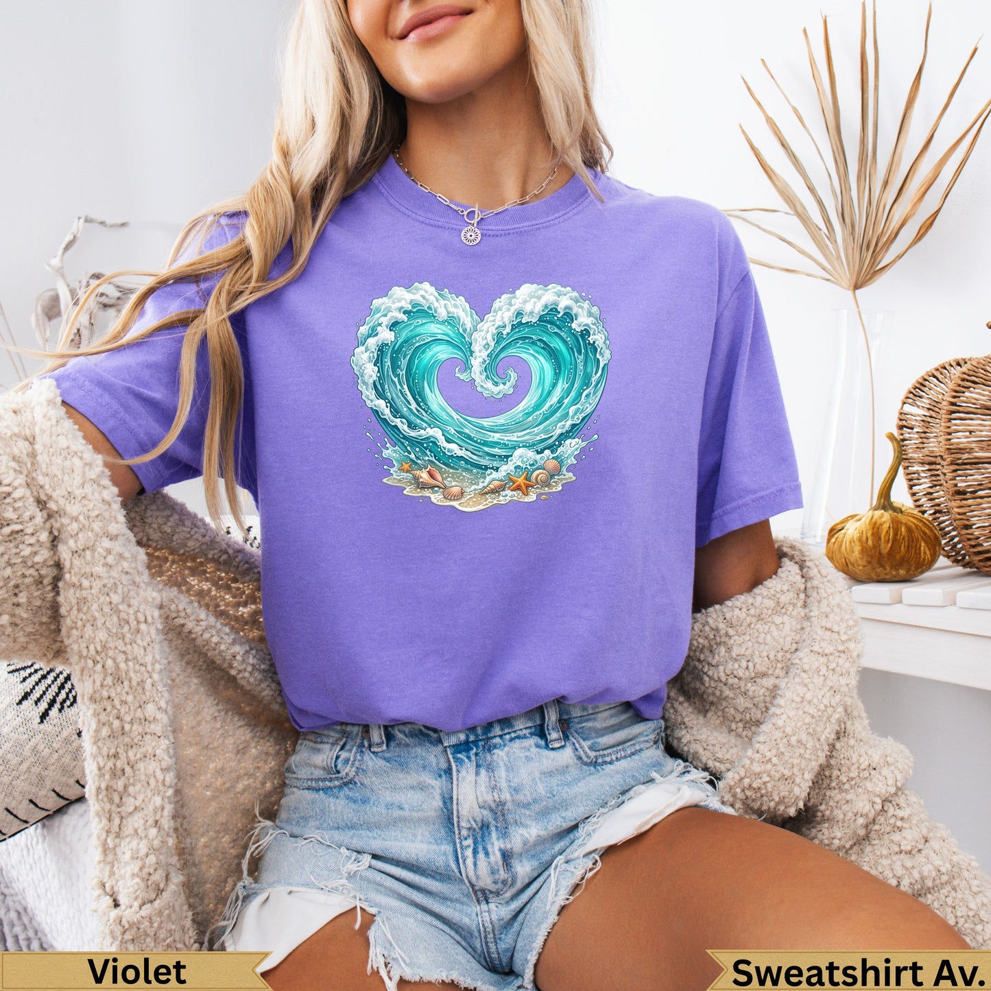 Purple t-shirt with a heart-shaped wave and seashell graphic.