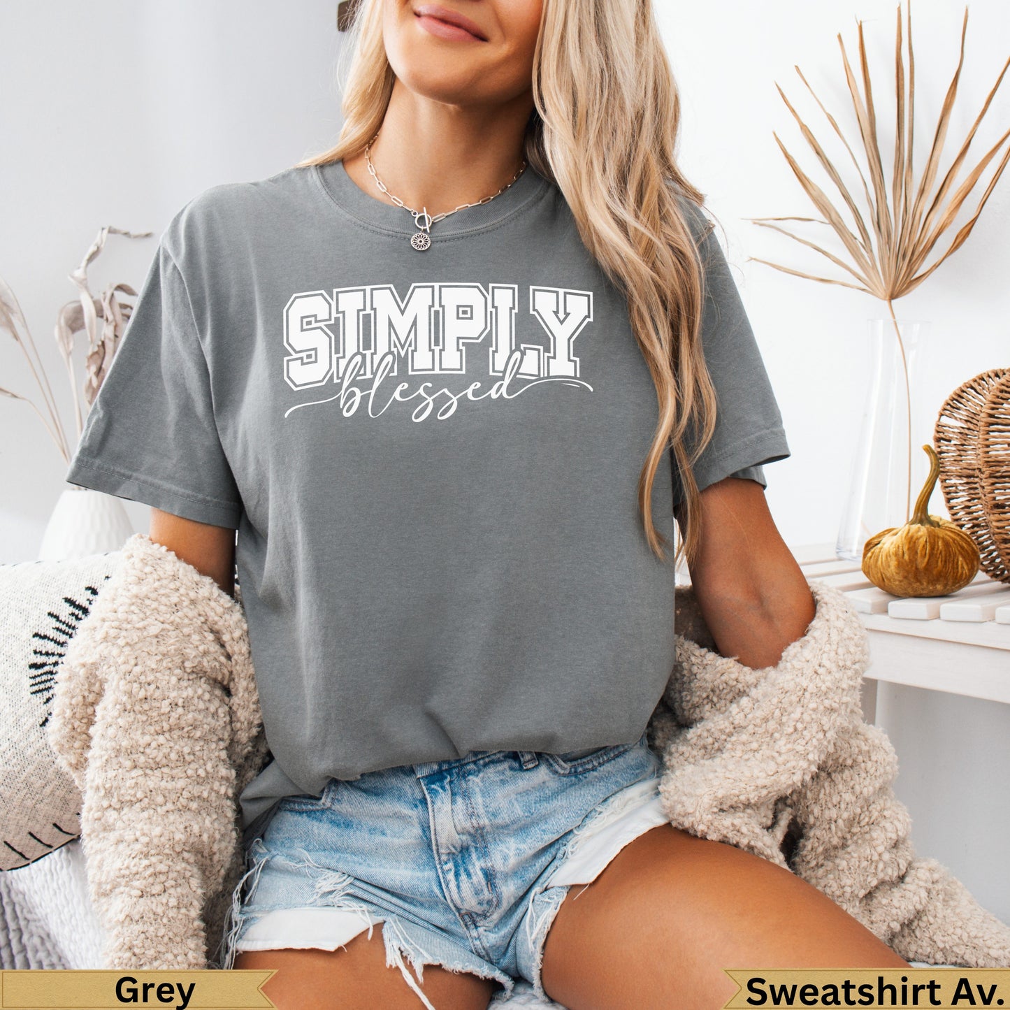 Grey t-shirt with "SIMPLY blessed" text, worn by a person.